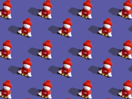 Seamless pattern with Christmas snowman on the backdrop of the trendy 2022 color of the year Very Peri. pattern background of Christmas snowman. Merry Christmas and Happy Holidays greeting card.の写真素材