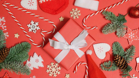 Christmas background. Fir tree branches, gift box and festive presents. New year gifts, holiday and celebration concept. Christmas decorations, preparing for the festive seasonの写真素材