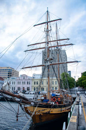 Pirate ship docked at a town pier with buildings in the backgroundのeditorial素材