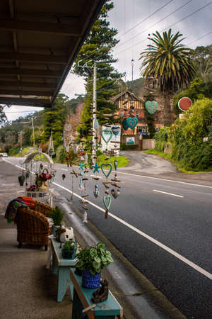 Colorful wind chimes outside of a store in front of a country roadのeditorial素材