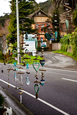Colorful wind chimes outside of a store in front of a country roadのeditorial素材
