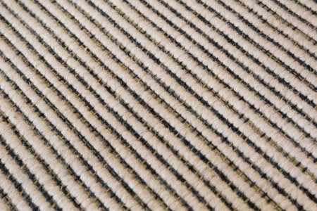 Close view of a black and white striped carpet. Macro and slanted perspective