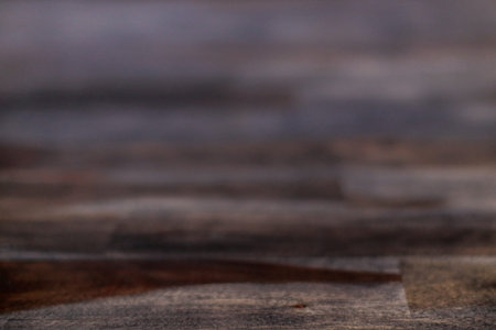Close up view of a wooden table with tables in bluish, brown and purple tones
