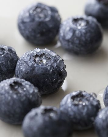 Close up of fresh blueberries with water droplets.の写真素材