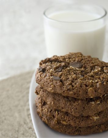 Oatmeal chocolate chip cookies with a glass of milk.の写真素材