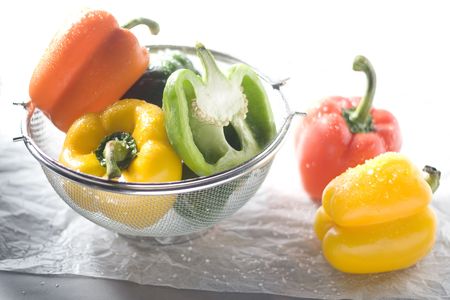 Highkey shot of yellow, red and green bell peppers.の写真素材