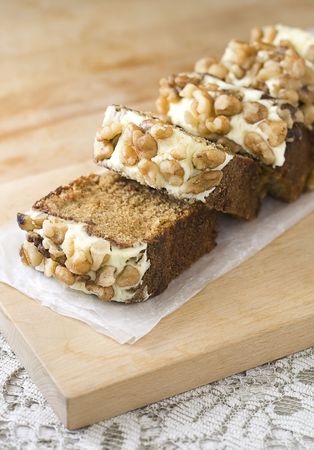 Carrot cake slices on wood board with lace tablecoth.の写真素材
