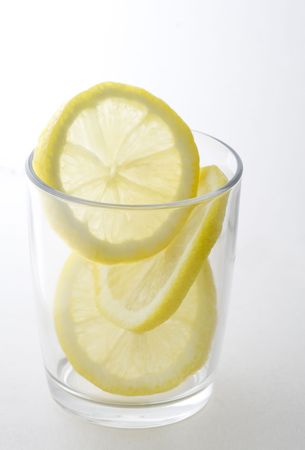 Lemon slices in clear glass on white background.の写真素材