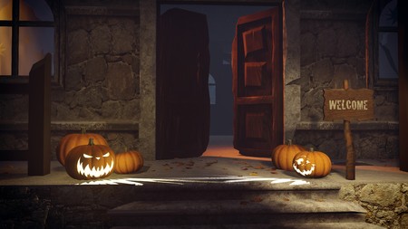 Carved pumpkins and Welcome sign on the porch of the gloomy house at nightの写真素材