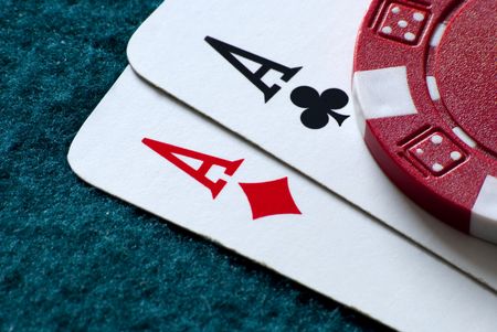 two aces and a chip on a gambling tableの写真素材