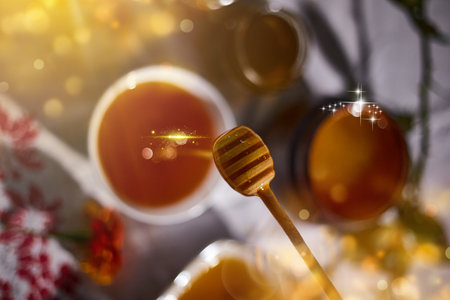 a jar of sweet honey on a table from the garden with apples in a glass jar with cheese and roses and fresh bread with bright light beautiful decoration creative photo in a bucket on a wooden table in the garden with flowers for breakfast delicious food. High quality photoの写真素材