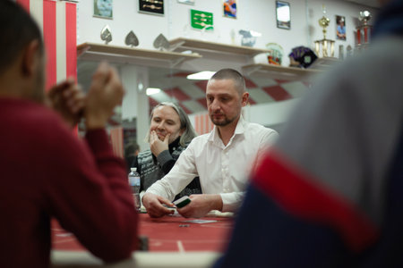 Texas club poker tournament which was in Ukraine in Kyiv in September 2020. Texas Holdem fans gathered together to play sports poker cards. High quality photoのeditorial素材