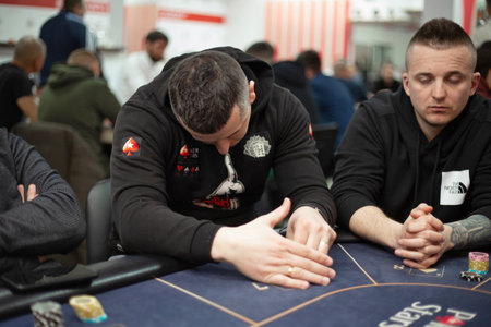 Texas club poker tournament which was in Ukraine in Kyiv in September 2020. Texas Holdem fans gathered together to play sports poker cards. High quality photoのeditorial素材