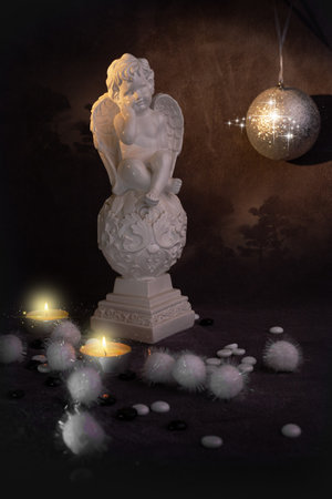 angel with wings Christmas holiday candle figurine statue ornament beautiful decoration with a ball . High quality photoの写真素材
