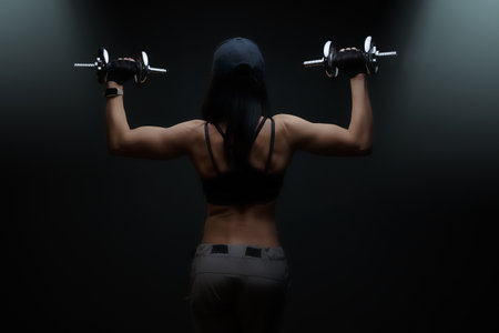 beautiful cute sports girl, fitness model, gym trainer, brutal, muscular athletic, bodybuilding lady sexy working out training pumping up muscles gaining weight and poses. healthy lifestyleの写真素材