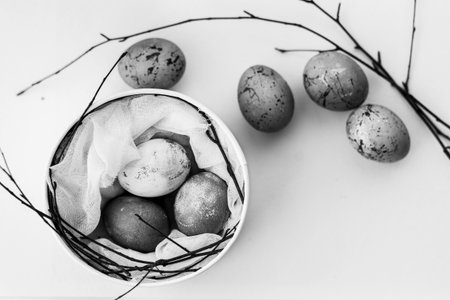 Easter eggs in a basket on a white background. Black and white photo.