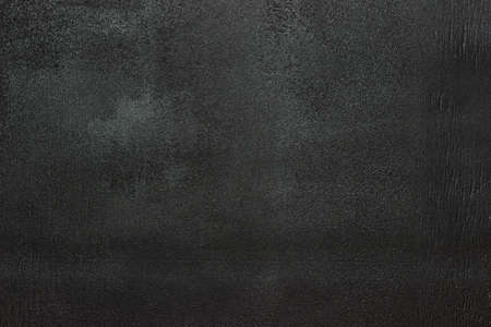 Clean black chalk board. Black background, textured.の写真素材