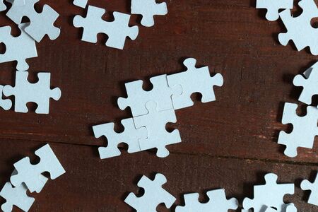 Puzzle pieces scattered on the table. Space for your textの写真素材