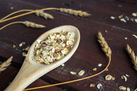 The wooden spoon in which the oatmeal is placed. Healthy lifestyle. Wooden spoon with oatmeal on a wooden tableの写真素材