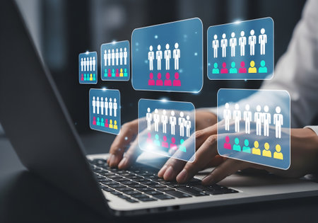 Closeup of hands typing on a laptop with virtual team icons, representing human resource management, business strategy, and digital collaboration in a modern office settingの素材