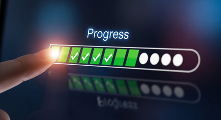 A progress bar on a screen shows completion with checkmarks. A finger hovers near the bar, indicating interaction. Digital advancement.の素材