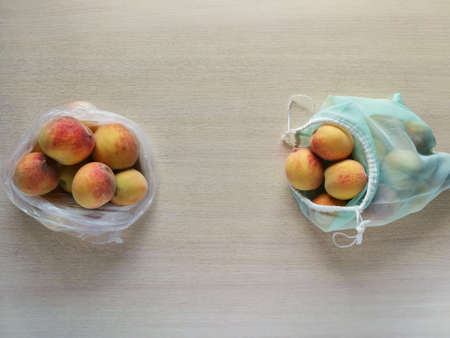 Peaches in plastic bag and reusable bag. Peaches in plastic bag and reusable bag.の写真素材