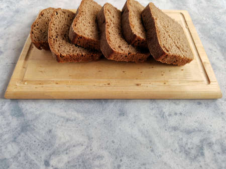 homemade rye bread on sourdough sliced on a wooden boardの写真素材