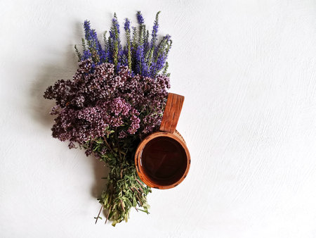 forest medicinal herbs for tea and a birch bark cupの写真素材