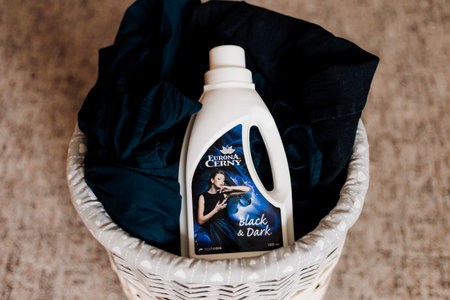Bottle with washing gel for washing dark laundry from the Eurona brand in a laundry basketのeditorial素材