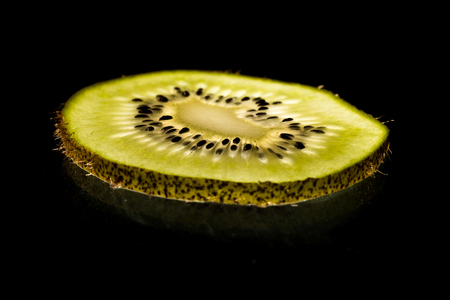close up macro kiwi slice lit from belowの写真素材