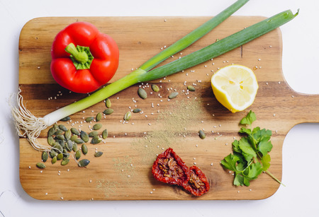 Board with food. Tomato, lemon, onion, dried pepper and parsleyの写真素材