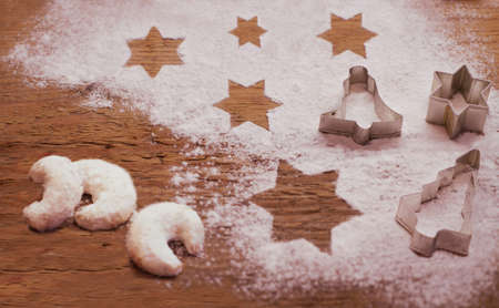 Christmas star shaped shortbread cookies with red ropes for Christmas tree decoration on white background, top view.の写真素材
