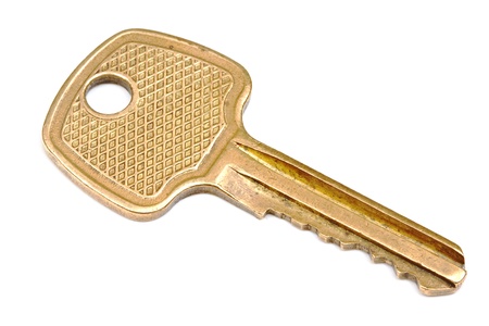Yellow metallic key isolated on whiteの写真素材