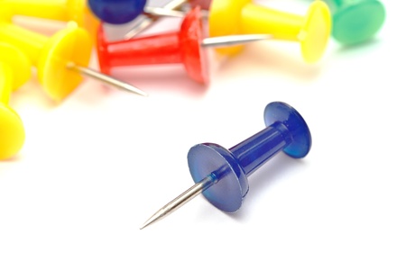 Colorful office push pins closup on whiteの写真素材