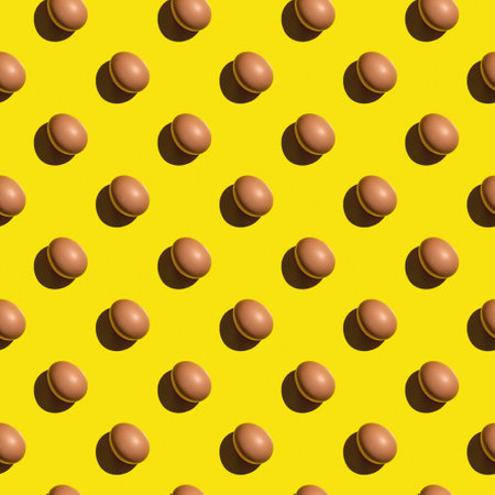 Seamless texture background pattern from eggs on a colored background. Minimal food conceptの写真素材