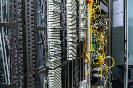 Crossing the telecommunication panel cable in the rack.