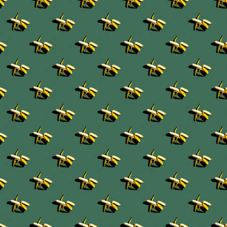 Seamless pattern of bananas on a uniform colored background.の写真素材