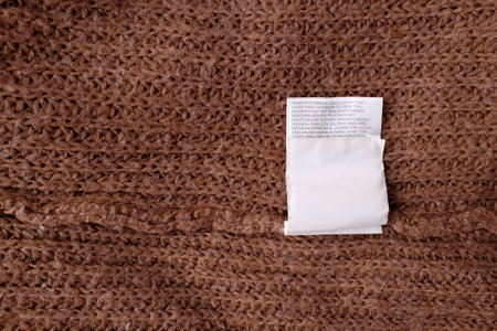 Clothing labels on wooden vintage background