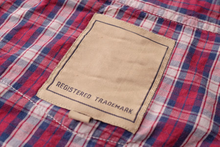 Clothing labels on wooden vintage background