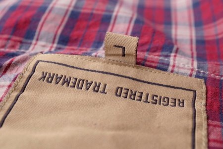 Clothing labels on wooden vintage background