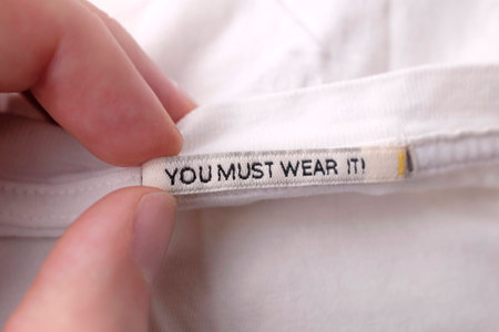 Clothing labels on wooden vintage background