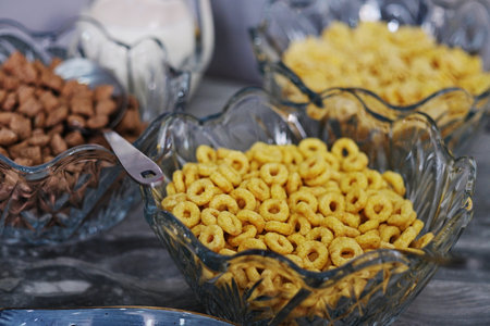 Bowls with cornflakes and milk on table, closeupの写真素材