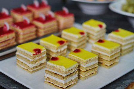 Close up of a stack of cakes with cherry jam on top.