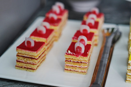 Close-up of a cake with red jelly on a plate.