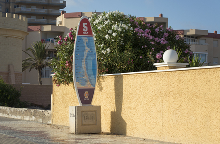Surfing Board Shaped Five Kilometers Touristic Milestone - La Manga del Mar Menor, Cabo de Palos, Cartagena and San Javier, Murcia, Spain, Europeのeditorial素材