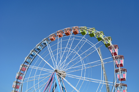 Colorful Amusement Park Big Wheel on Clear Blue Skyの写真素材