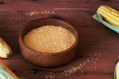 Corn grits on a wooden backgroundの写真素材