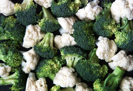 Pieces of ripe broccoli and cauliflower. Healthy background.の写真素材