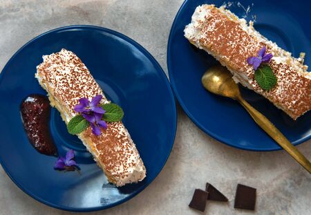 Swiss roll with cream, a piece of homemade roll cake on a plate.