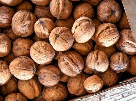 Top view walnuts in box on wooden background.の写真素材